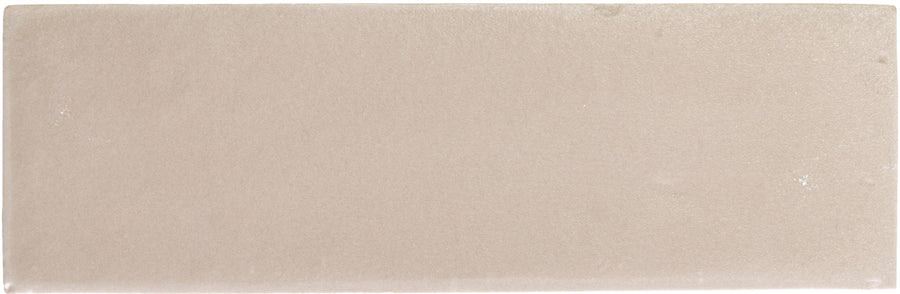 The Rebels 2" x 6" Matte Subway Tile in taupe features a smooth finish and subtle tonal variations, perfect for creating an accent wall.