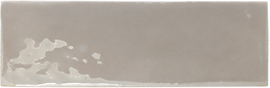 The Rebels 2" x 6" Matte Subway Tile is a rectangular taupe ceramic wall tile with a matte finish and subtle lighter glaze detailing along the bottom left edge.