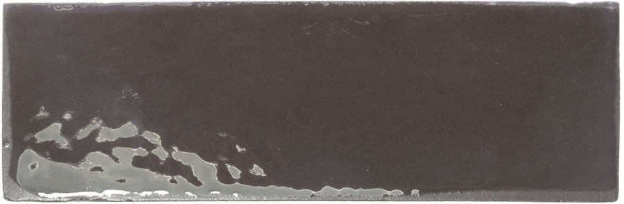 A rectangular 2" x 6" Rebels Matte Subway Tile with a sleek black finish and subtle texture variation—ideal for accent walls, especially along the bottom left edge.