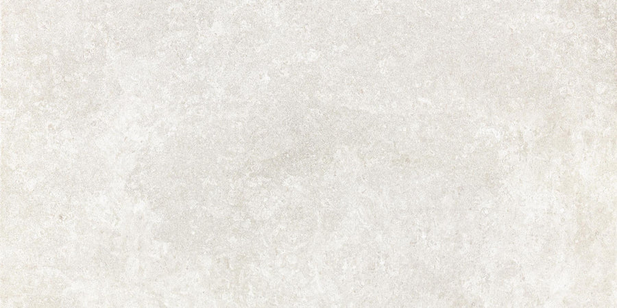 The Revolve 12x24 Rectified Porcelain Tile features a lightly textured, off-white surface with subtle tonal variations and faint speckles, offering a three-dimensional look reminiscent of concrete or stone.
