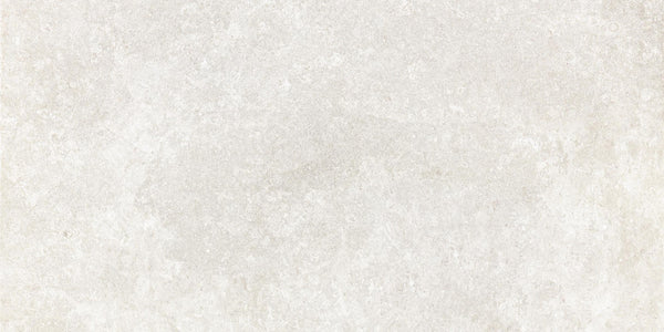 The Revolve 12x24 Rectified Porcelain Tile features a lightly textured, off-white surface with subtle tonal variations and faint speckles, offering a three-dimensional look reminiscent of concrete or stone.