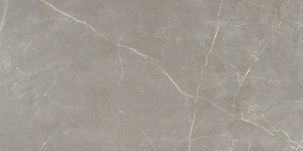 The Callie 12x24 Matte Porcelain Tile in Fog features a gray marble look with subtle white veining and natural stone texture, creating an elegant, smooth finish ideal for luxury countertops, floors, or wall applications.