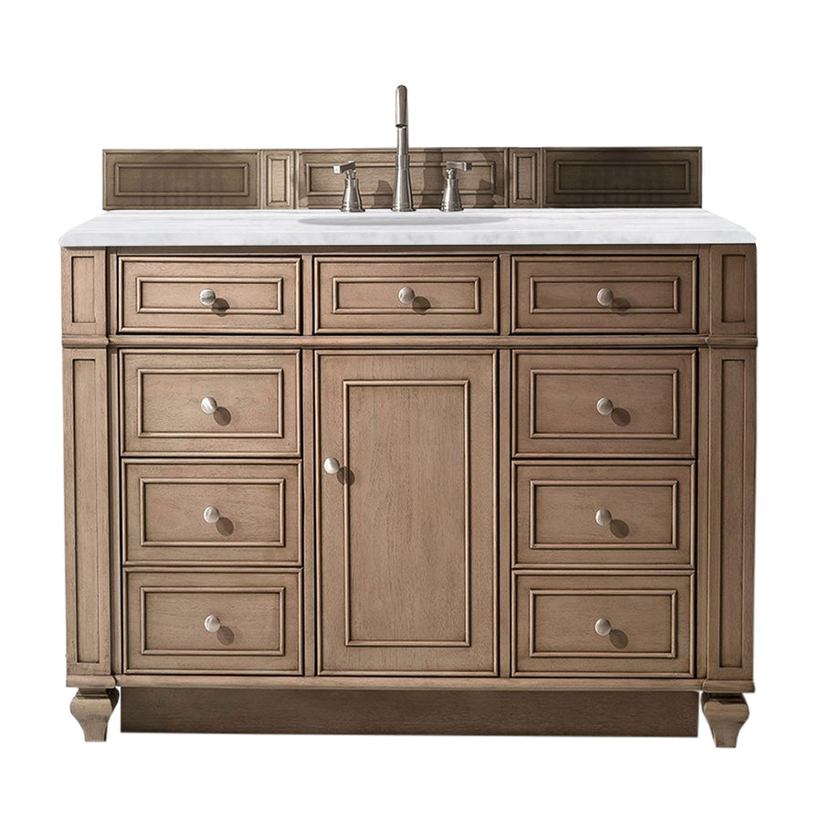 A wooden bathroom vanity with a marble countertop, silver faucet, and multiple drawers and cabinet doors, isolated on a white background.
