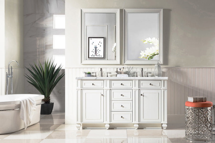 A bright, elegant bathroom features a Bristol 60" Double Bowl Vanity, double mirrors, a potted plant, white bathtub, and an orange-cushioned stool. Decor is minimal with light walls and marble floor tiles.