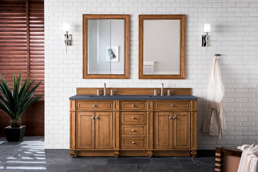A transitional bathroom includes the Bristol 72" Double Bowl Vanity, two mirrors, white subway tile walls, modern sconces, a towel on a hook, a potted plant, and wooden blinds on the left.