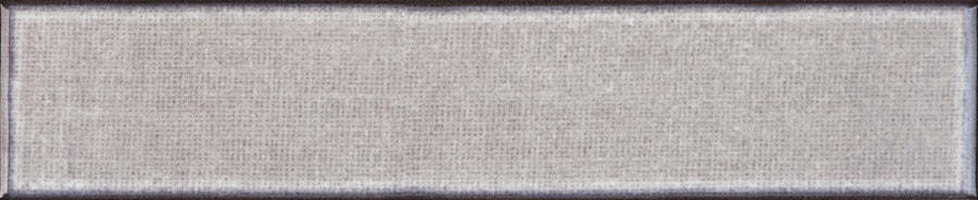 A close-up of the Texstyle 2" x 10" Combed Subway Tile in Stormy shows its rectangular shape, textured surface with visible combed lines, and slightly deeper-toned edges that create a subtle border effect reminiscent of hand-combed finishes.