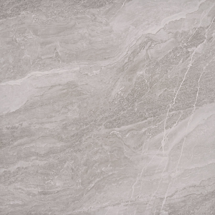 A close-up of the Veil 48" x 48" Tile in Mystic Natural showcases gray marble with wavy patterns and white veins, offering timeless sophistication—ideal for luxury flooring or elegant large-format installations.