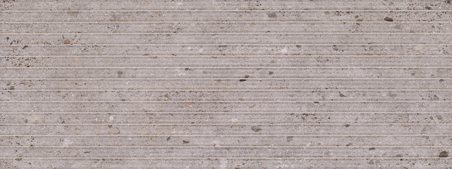 Strata 18" x 48" Deco Tile in Cinder features a textured concrete look with vertical white lines, scattered dark spots, and subtle color variation—perfect for creating a striking feature wall.