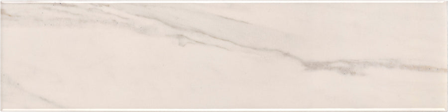 The Lunara Haze 4" x 16" Subway Tile features a glossy white marble look with subtle gray diagonal veining. Its polished finish and soft color variations make it perfect for accent walls, adding a touch of modern elegance to any space.