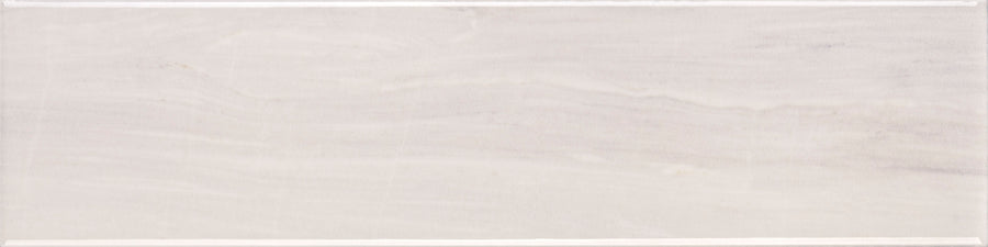 The Lunara Comet 4" x 16" Subway Tile features a glossy light beige finish with subtle horizontal streaks and defined edges, adding stone-like elegance to accent walls or backsplashes in any space.