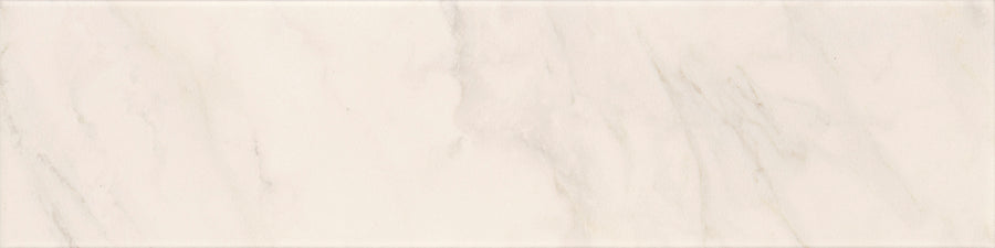 The Tuscany Oro 4" x 16" tile has a matte, smooth white surface with soft light gray, beige, and golden veining that mimics natural marble for a clean, elegant look.