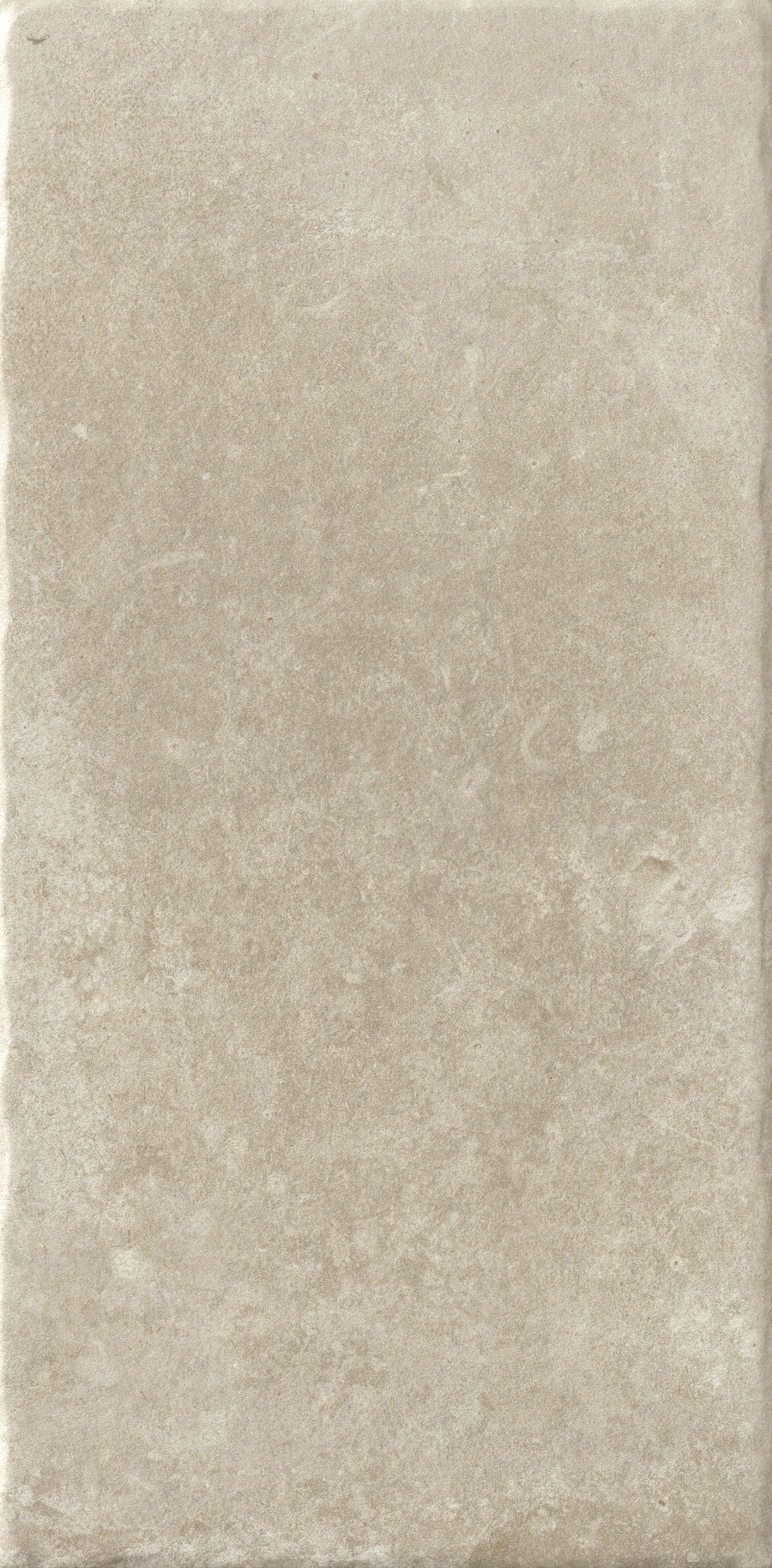 The VersaTILE 8x16 Glazed Porcelain Tile in Belgian Light features a rectangular shape, slightly textured matte finish, subtle color variations for a stone-like look, and gently uneven edges for added rustic charm.