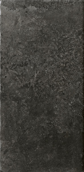 The VersaTILE 8x16 Glazed Porcelain Tile in Belgian Dark features a textured surface with subtle color variations and rough patterns, creating a sophisticated, natural look ideal for upscale interiors.