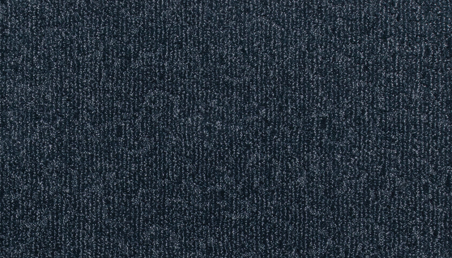 Close-up view of the Fleurious Pet Friendly Carpet, featuring a textured, dark gray surface with a subtle pattern and durable looped construction, providing luxurious comfort underfoot.