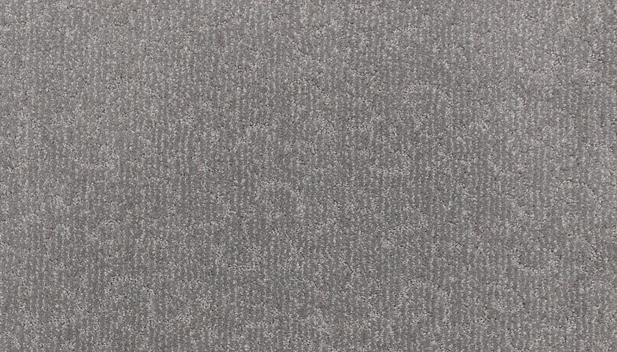Close-up of Fleurious Pet Friendly Carpet in textured gray, featuring a subtle, irregular wavy pattern. The soft, slightly raised fibers add luxurious comfort and depth to the uniform color while being ideal for pet-friendly homes.