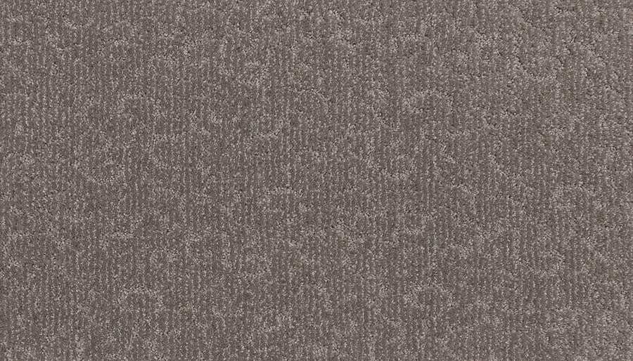 Close-up of Fleurious Pet Friendly Carpet in light brown, featuring a subtle swirling pattern. Its soft, densely packed fibers offer plush comfort and premium style, making it perfect for luxurious yet durable flooring.