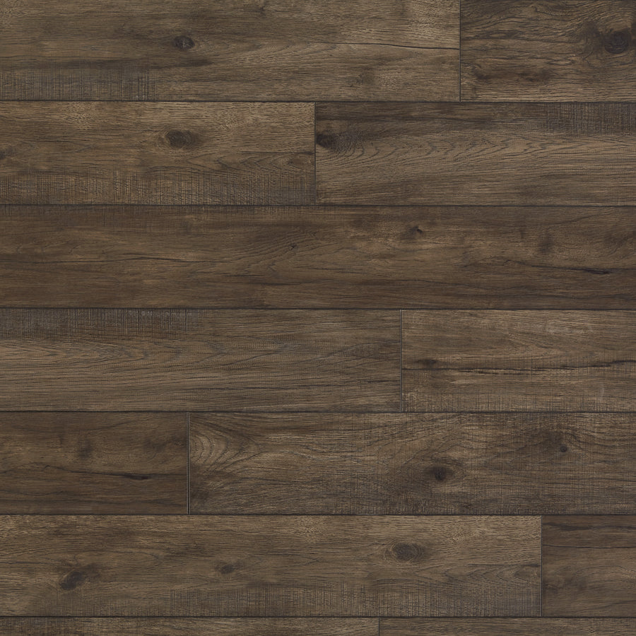 Hillside Hickory 7 9/16" Waterproof Laminate in Coal features wide, dark brown planks with a natural wood grain pattern, subtle color variation, and visible knots for added texture. The smooth surface highlights the authentic look of real wood.