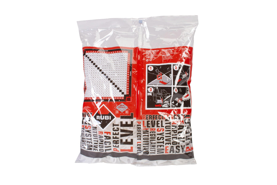 A clear plastic bag with red and black graphics contains white tile spacers for precise installation. The front displays the Rubi Delta Leveling System name, instructions, brand details, and helpful illustrations.