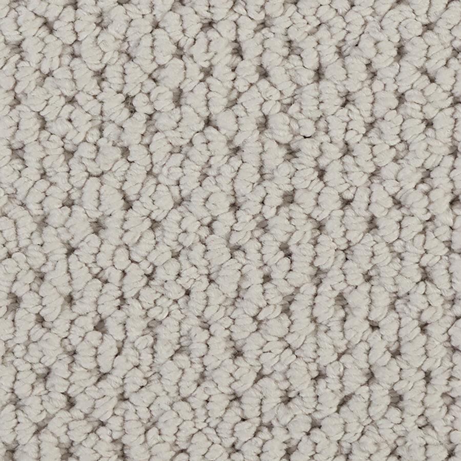 Close-up of Kinetic Detail Berber Carpet in light beige, featuring tightly woven looped fibers for a soft, uniform texture. Its plush surface is ideal for cozy indoor flooring and stylish interior design.