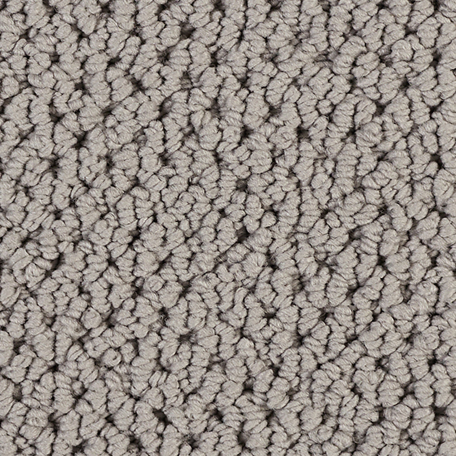 Close-up view of the Kinetic Detail Berber Carpet in light gray, showcasing its textured loop-pile pattern and soft, bumpy surface—an elegant choice to enhance any interior design.