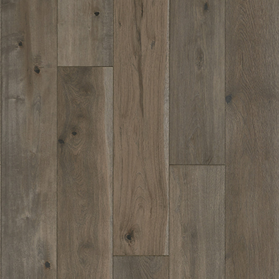 A close-up of Anthology 7 9/16" Waterproof Laminate in Quill, showing wood-look floorboards with a natural grain, subtle knots, and rustic brown and gray tones.