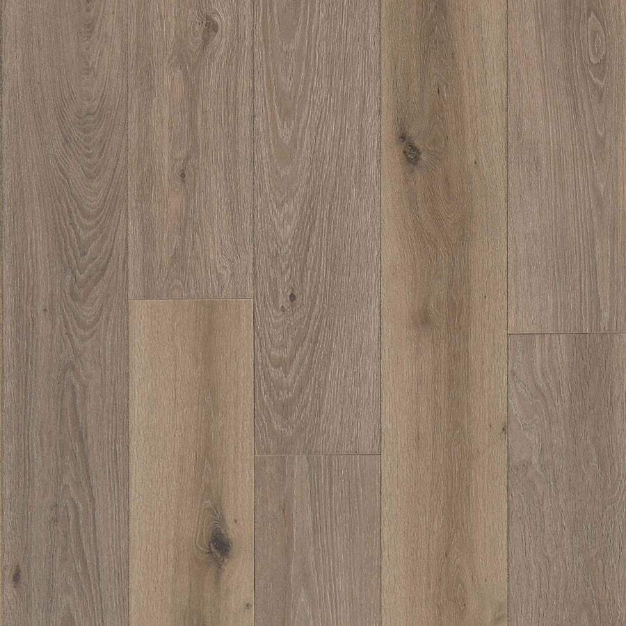 Haven 7 9/16" Waterproof Laminate in Toast features light brown floorboards with visible wood grain and knots, laid vertically for a natural, rustic look.