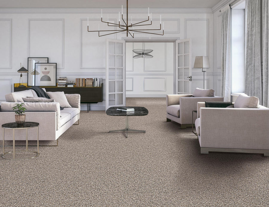 A modern living room with beige carpet, two light-colored armchairs, a sofa, a black coffee table, minimalist wall art, a chandelier, and large windows with sheer curtains. Double doors open to another elegant room.