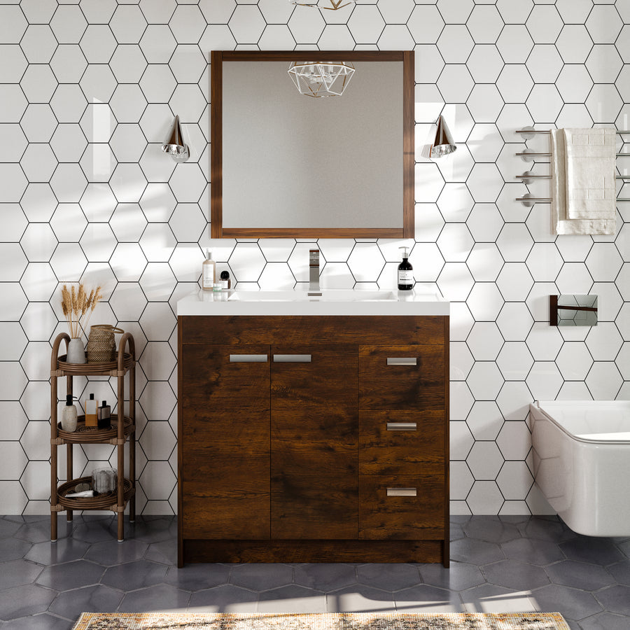 Modern bathroom with a wooden vanity, rectangular mirror, hexagonal white tile walls, geometric floor tiles, pendant lights, and a small wooden shelf holding toiletries and decor.
