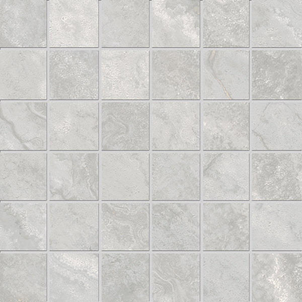 The Stream 2x2 Mosaic Porcelain Tile features square light gray tiles with subtle texture and shade variations, mimicking natural travertine. Made with 3D Shaped Technology, the tiles are evenly spaced and have thin grout lines.