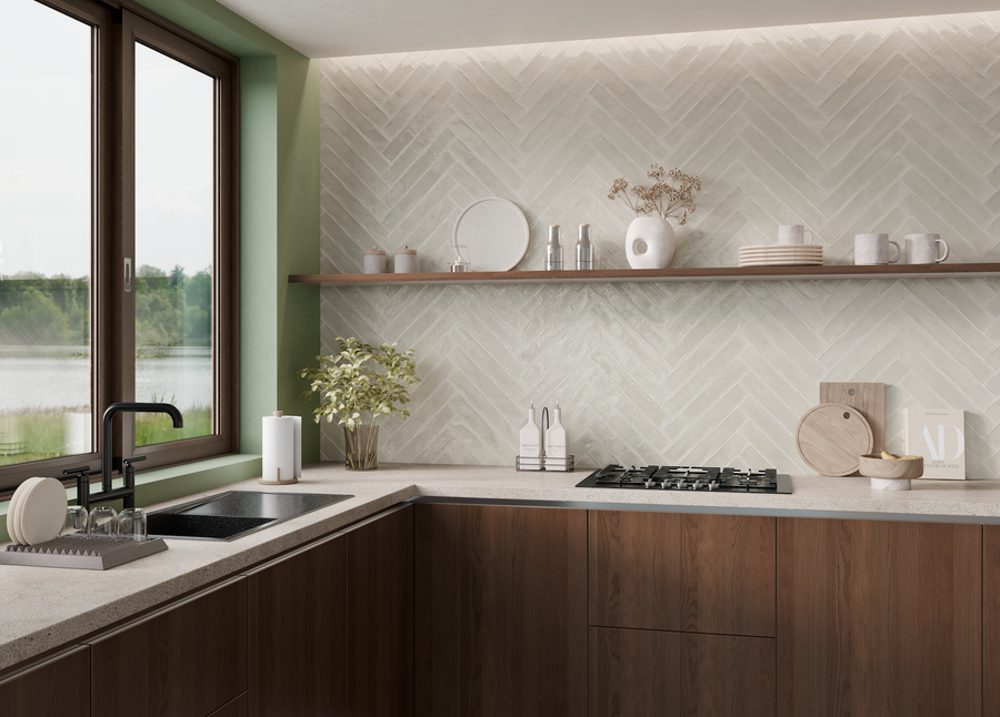 Modern kitchen with dark wood cabinets, a light countertop, a black sink, and a gas stove. A wooden shelf holds dishes and decor above a white herringbone tile backsplash. Large window overlooks greenery.