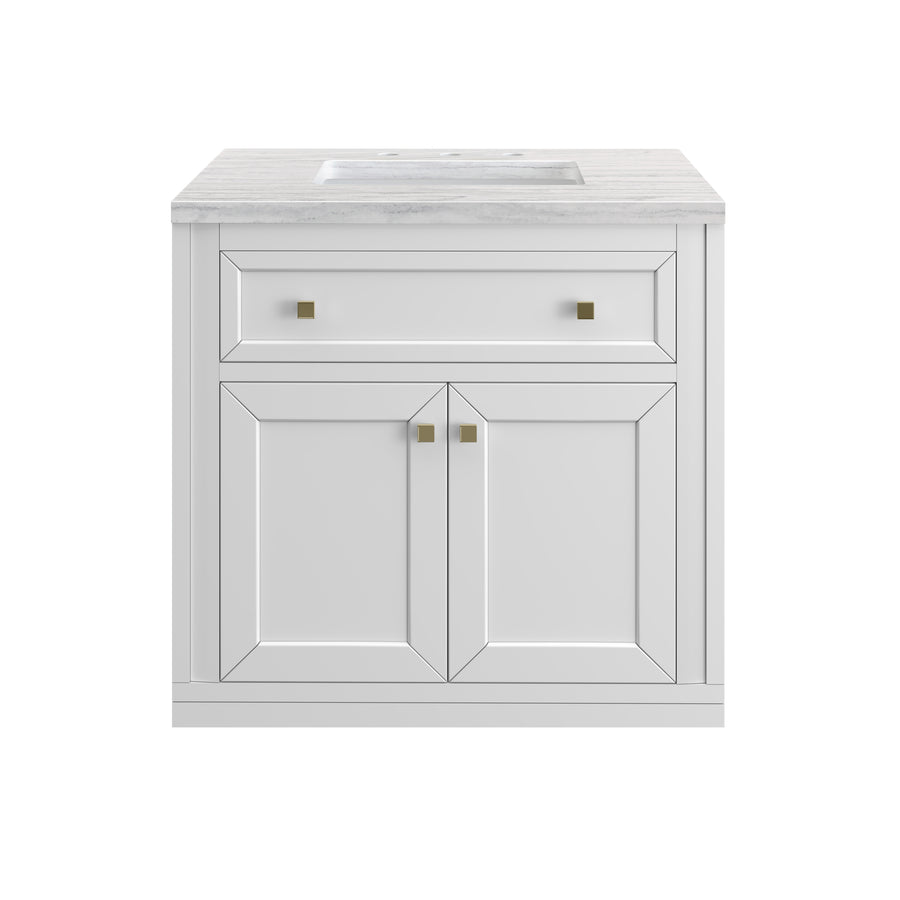 A white bathroom vanity with a marble countertop, a rectangular sink, one upper drawer with two square handles, and two cabinet doors with matching handles.