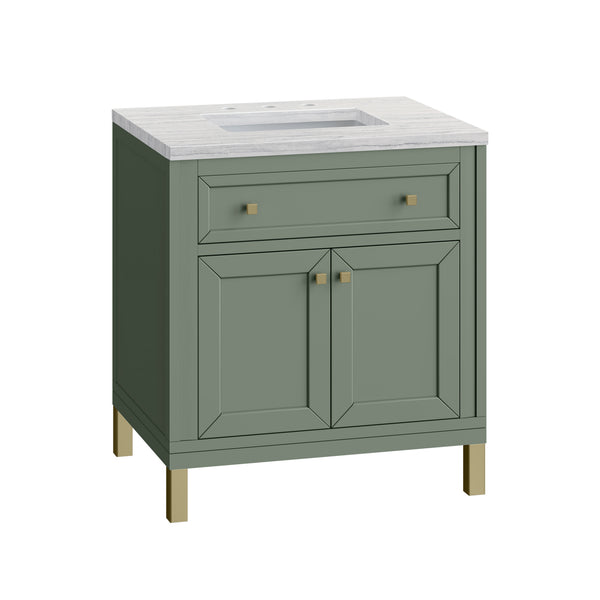A green bathroom vanity with a white countertop, built-in sink, two cabinet doors, a top drawer, and gold-colored handles and leg accents.