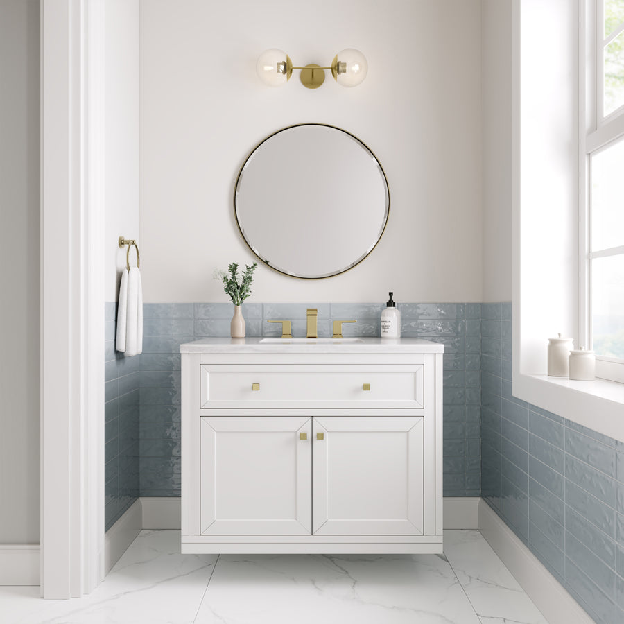 Modern bathroom featuring the Chicago 36" Vanity in white, gold fixtures, round mirror, wall-mounted light, blue tile backsplash, marble floor, and a window with natural light. A plant and soap dispenser add a luxe accent to the vanity.