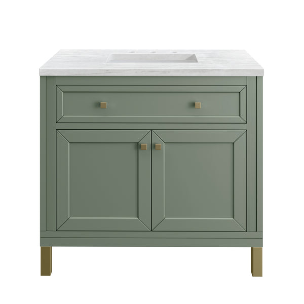 A green bathroom vanity with gold hardware, two cabinet doors, a single upper drawer, and a white rectangular countertop sink.