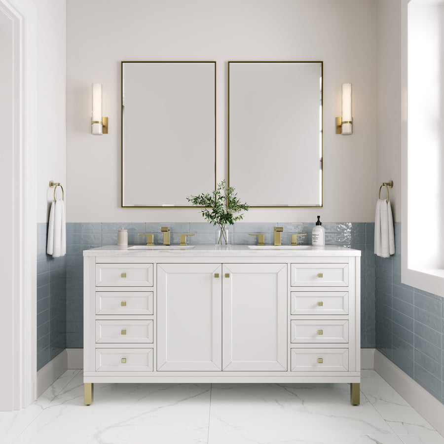 A modern bathroom showcases the Chicago 60" Double Bowl Vanity with gold hardware, two square mirrors, wall-mounted lights, a blue tile backsplash, white walls, marble flooring, and a vase with greenery on the vanity.