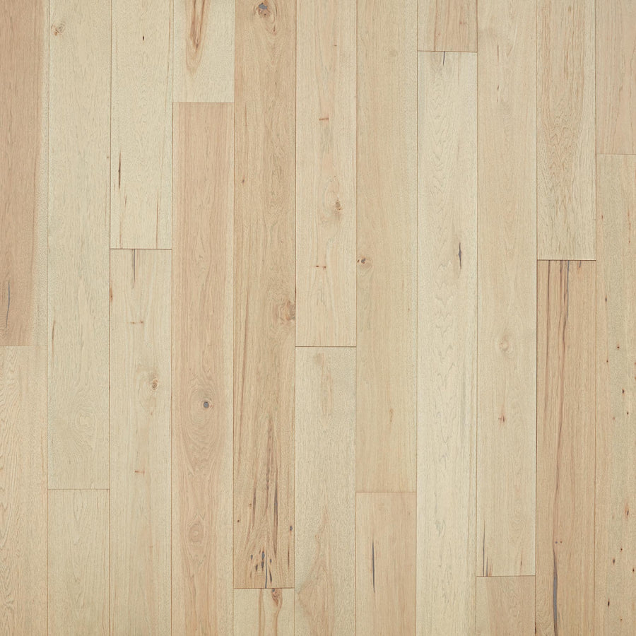 Rockford 7 1/2" Hickory Hardwood floorboards feature a light color, natural grain with knots, subtle wood tone variations, and a smooth, polished surface for a premium look. Boards are arranged in a staggered pattern.