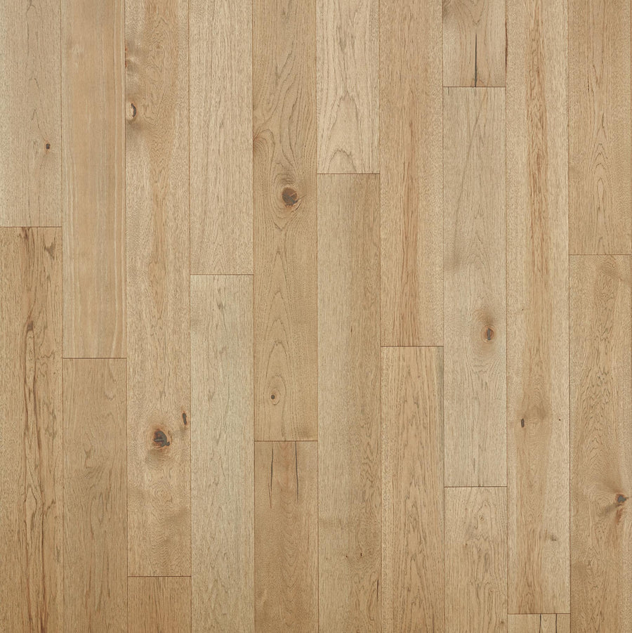 Rockford 7 1/2" Hickory Hardwood features luxurious, light-colored planks with natural grain patterns and knots. Its smooth, clean surface creates a warm, inviting look—ideal for premium flooring in any space.
