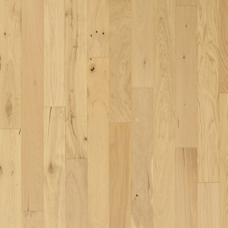Close-up of Englewood White Oak 5" Hardwood flooring, displaying natural grain patterns, small knots, and subtle tone variations. The European white oak planks are laid in a consistent, straight arrangement.