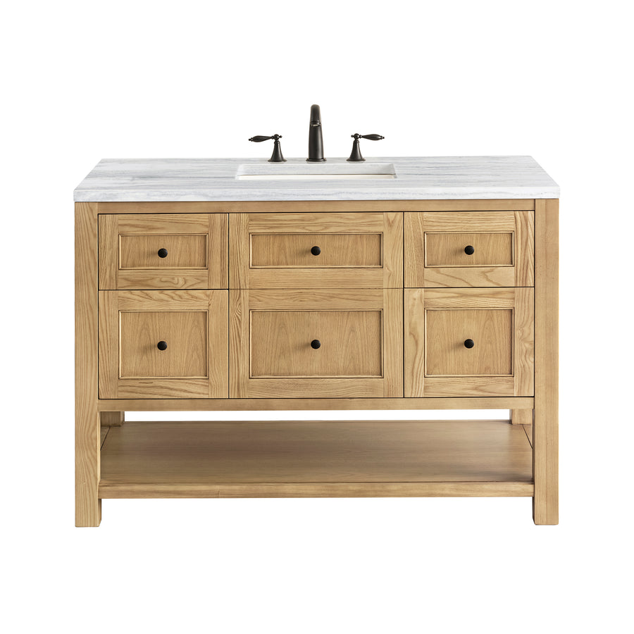 A wooden bathroom vanity with a white countertop, built-in sink, bronze faucet, six drawers, two cabinet doors, and an open lower shelf, photographed on a white background.