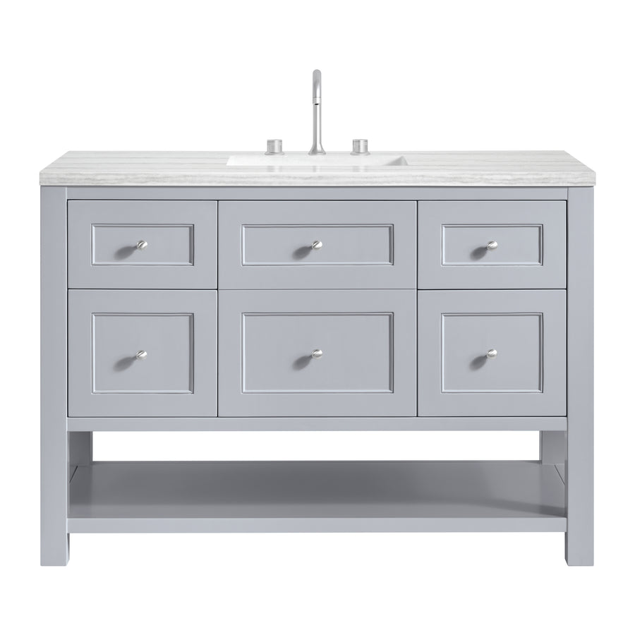 A gray bathroom vanity with six drawers, a lower open shelf, a marble countertop, an undermount sink, and a modern faucet.
