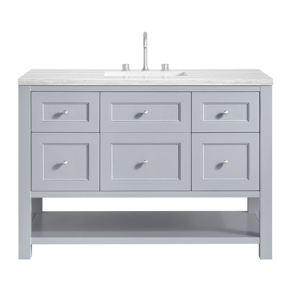 A gray bathroom vanity with six drawers, a lower open shelf, a marble countertop, an undermount sink, and a modern faucet.