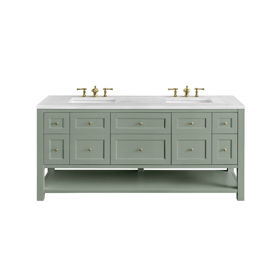 A sage green double-sink bathroom vanity with a white countertop, gold faucets and hardware, six drawers, four cabinet doors, and an open lower shelf.