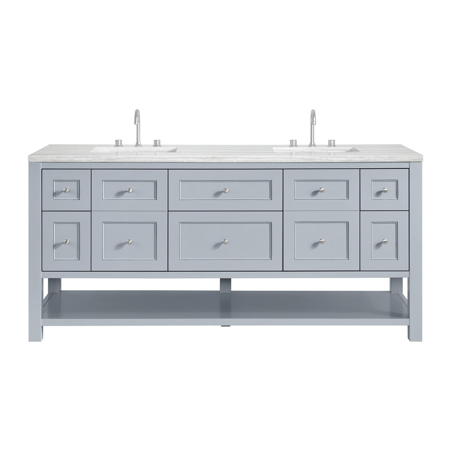 A light blue double-sink bathroom vanity with a white marble countertop, two faucets, multiple drawers, and an open shelf at the bottom, viewed from the front.