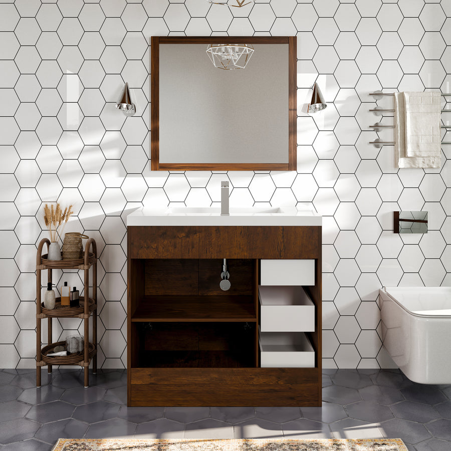 Modern bathroom with hexagon white tile walls, a wooden vanity with open drawers and empty shelves, a large mirror, metal wall lamps, a small shelf with decor, a towel rack, and a wall-mounted toilet.