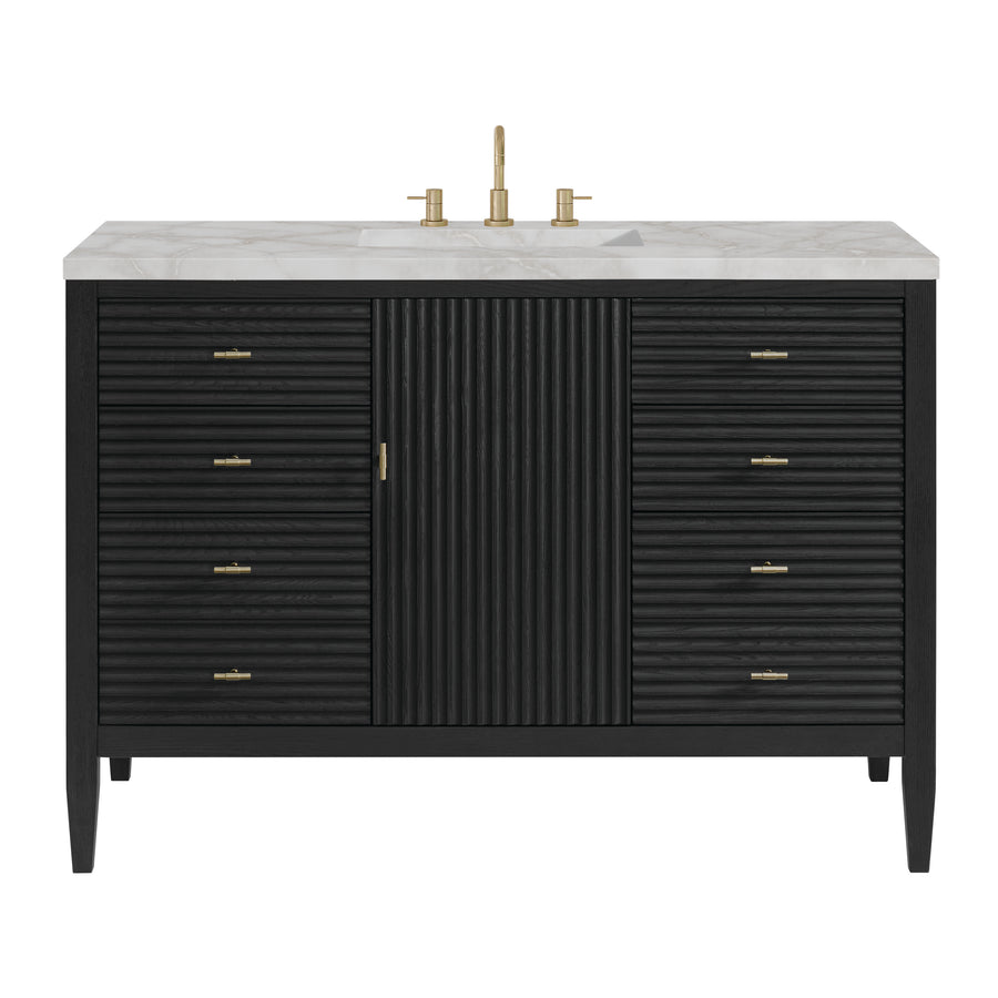 A modern black bathroom vanity with gold hardware, a ribbed central cabinet, six drawers on each side, a white marble countertop, and a gold faucet.