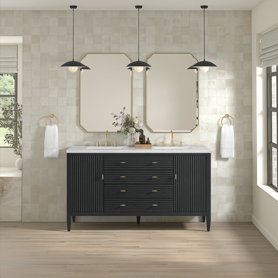 A modern bathroom features the Myrrin 60" Vanity with gold hardware, two rectangular mirrors, three black pendant lights, white tiled walls, gold towel rings with white towels, and a large window on the right.