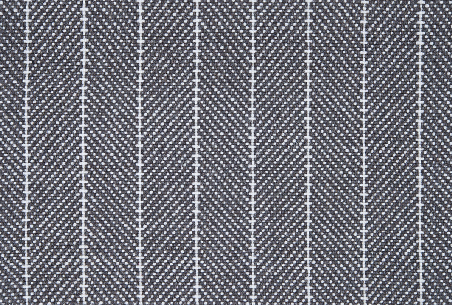 Close-up of Addington Berber Carpet in Charcoal shows a repeating herringbone pattern with thin vertical white lines, creating a zigzag effect reminiscent of premium flooring designs.