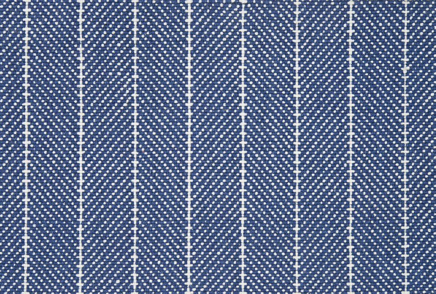 Close-up of Addington Berber Carpet in blue, showing a repeating herringbone pattern with diagonal white dashed zigzags and vertical white edges, evoking the textured look typical of premium Berber carpets.