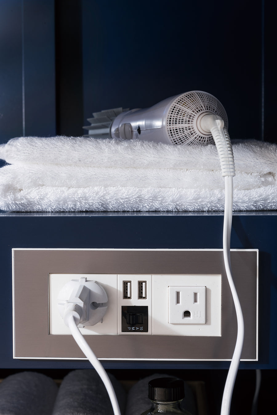 A hair dryer on a towel.
