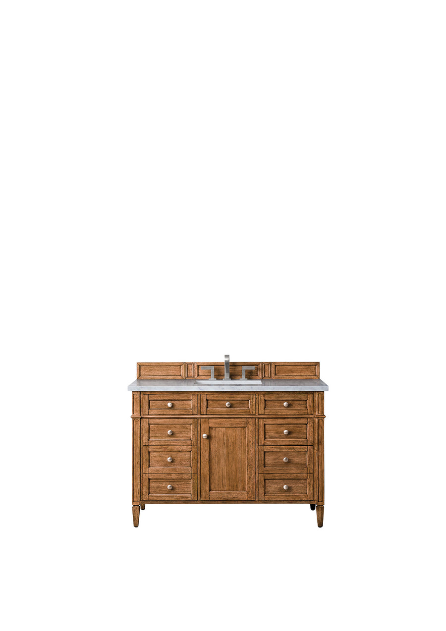 A wooden bathroom vanity with a marble countertop, central sink, silver faucet, and multiple drawers and cabinets for storage, set against a plain white background.